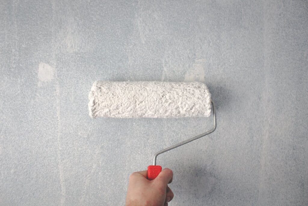 a person painting wall