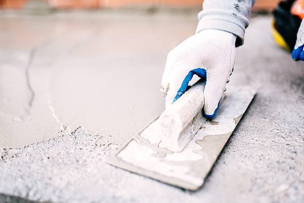 a man scraping putty