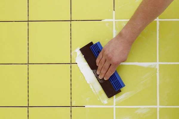 a man frouting yellow tiles